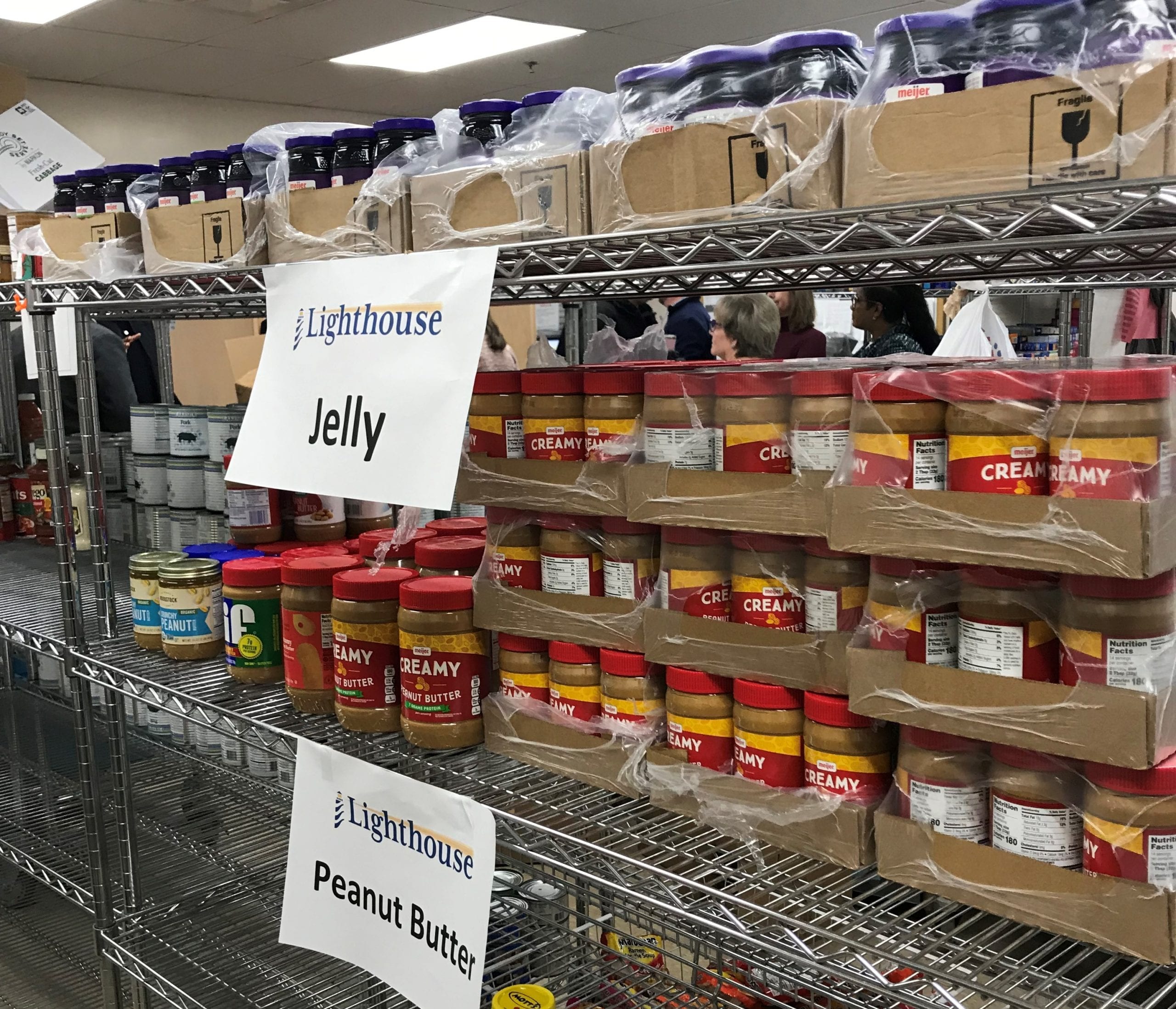 Rows of peanut butter and jelly on Lighthouse of Michigan's food pantry shelves.
